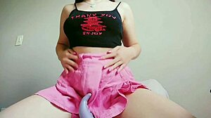 a naughty teen in pink skirt teases with hentai dildo. she masturbates natural tits with toys